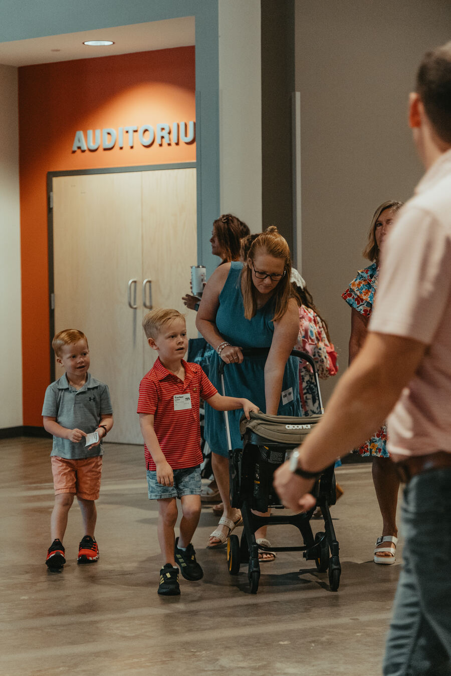 Children heading in past the auditorium doors.