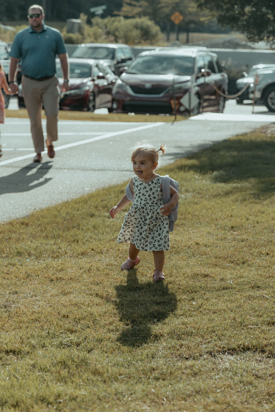 A toddler out on the grass.