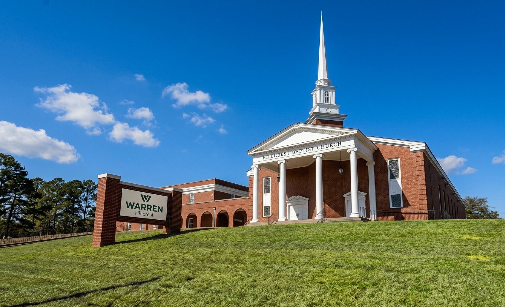 Warren Hillcrest: the white steeple and columned portico of the brick church on its hill, the Warren Hillcrest sign on the lawn.