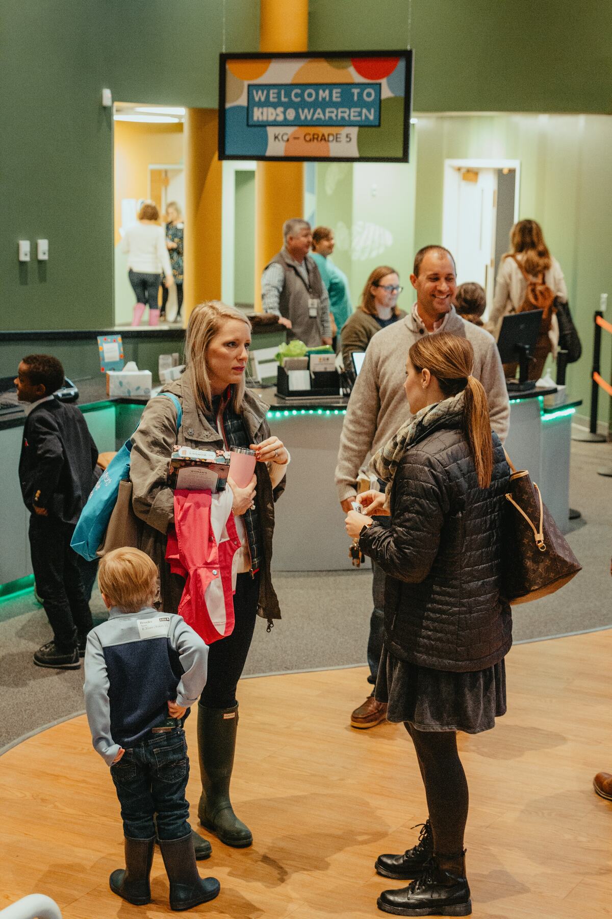 Parents and children at the Kids@Warren check-in desk.