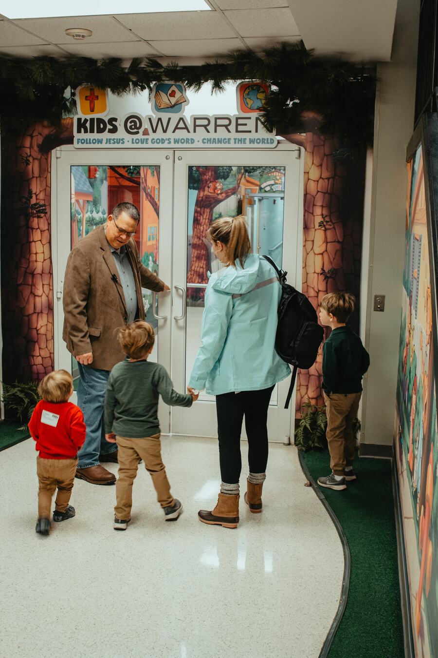 A family walking in through the Kids@Warren doors.