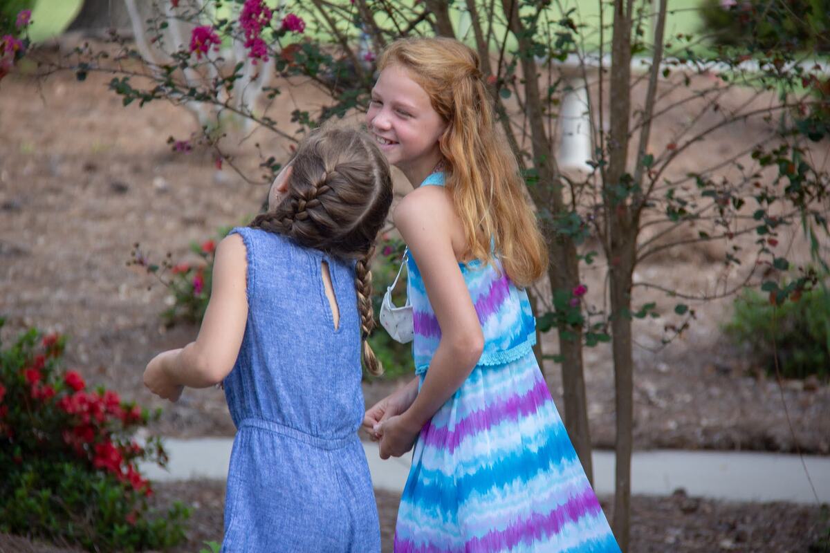Two children walking outside.