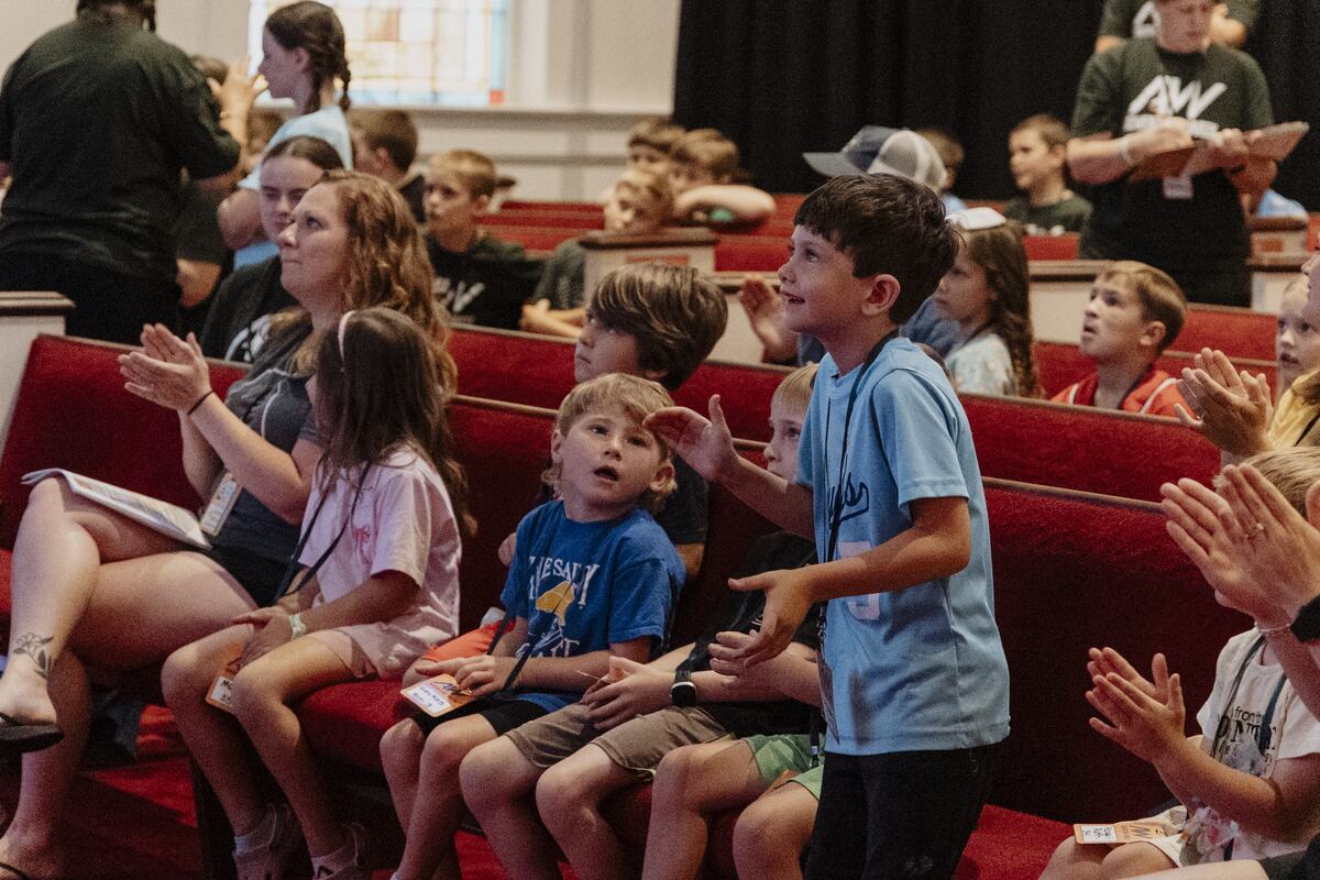 Children clapping along in the pews.