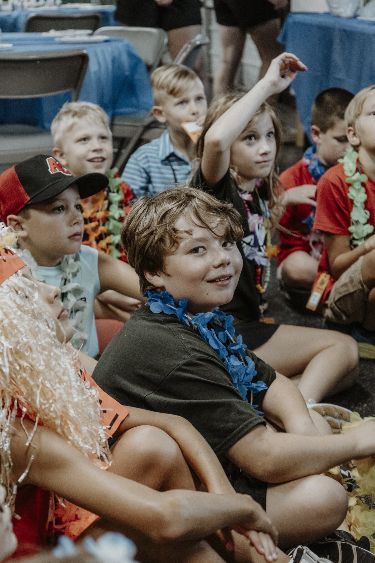 A group of children on the floor with a leader.