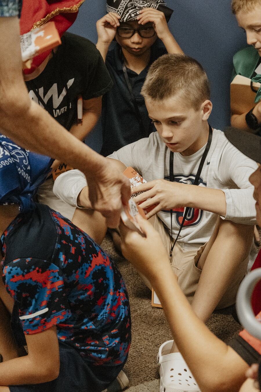 A leader helping a child with an activity.