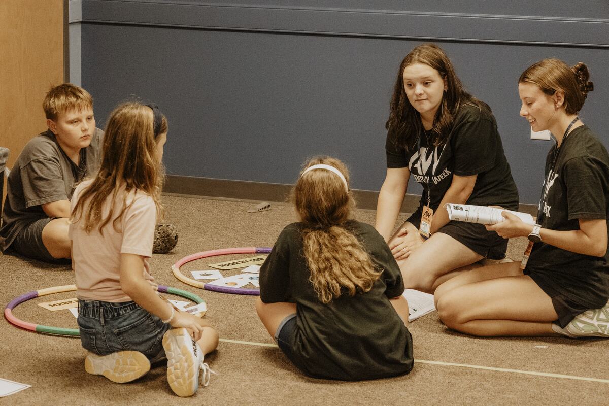 A leader with children and hula hoops.