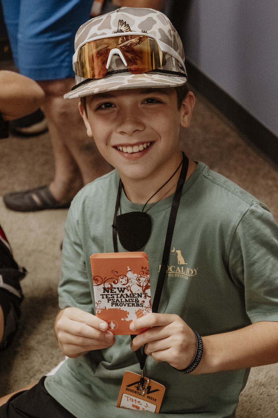 A child smiling in a name tag.