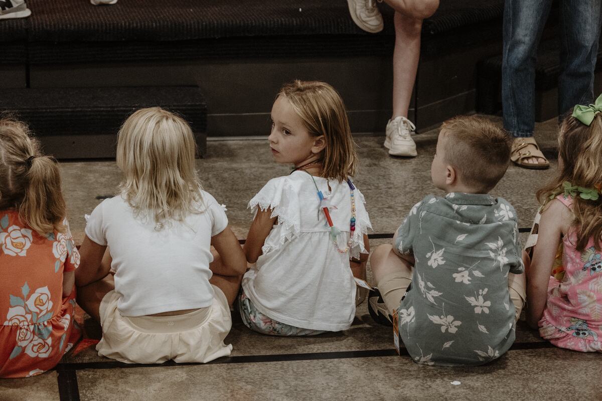 Children watching the front of the room.