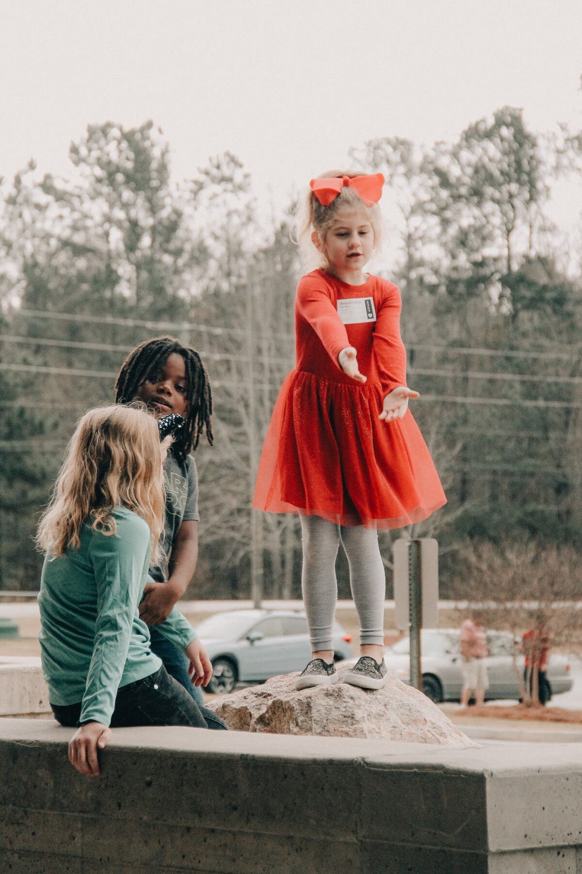 A child walking in hand in hand with an adult.