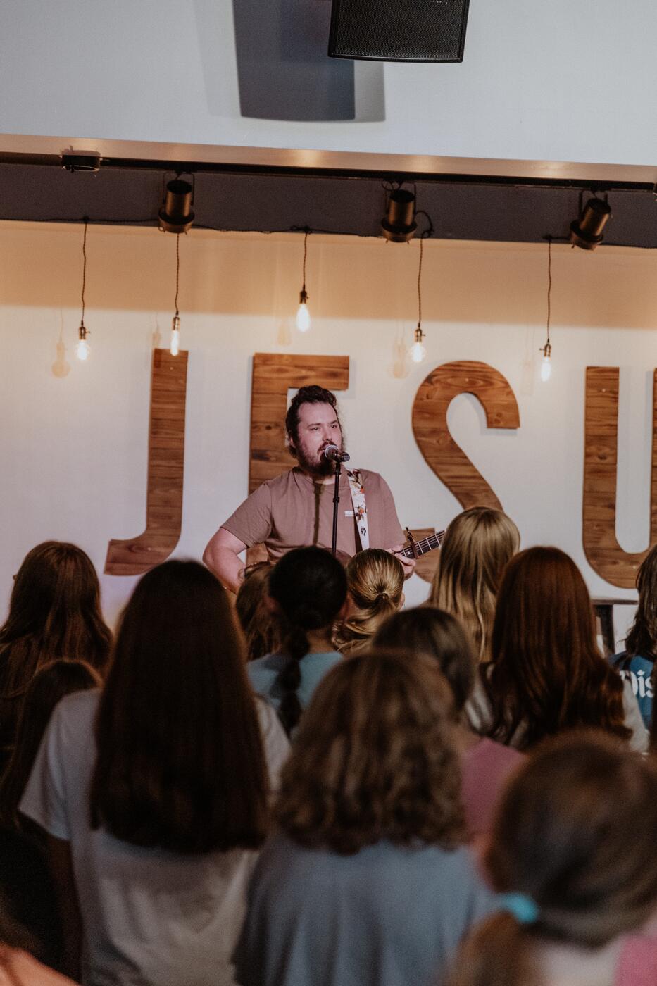 Students together under the JESUS letters.