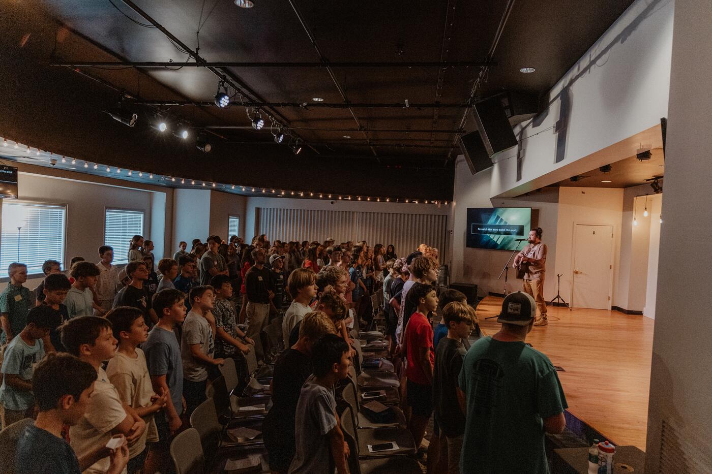 The student room full, facing the stage.