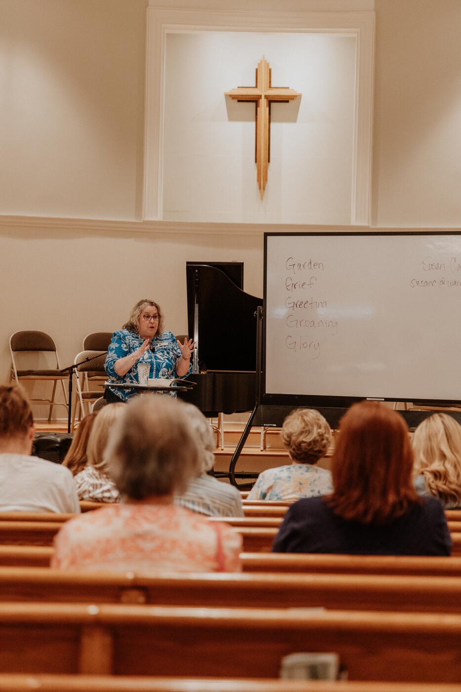 Teaching from the front of the sanctuary.
