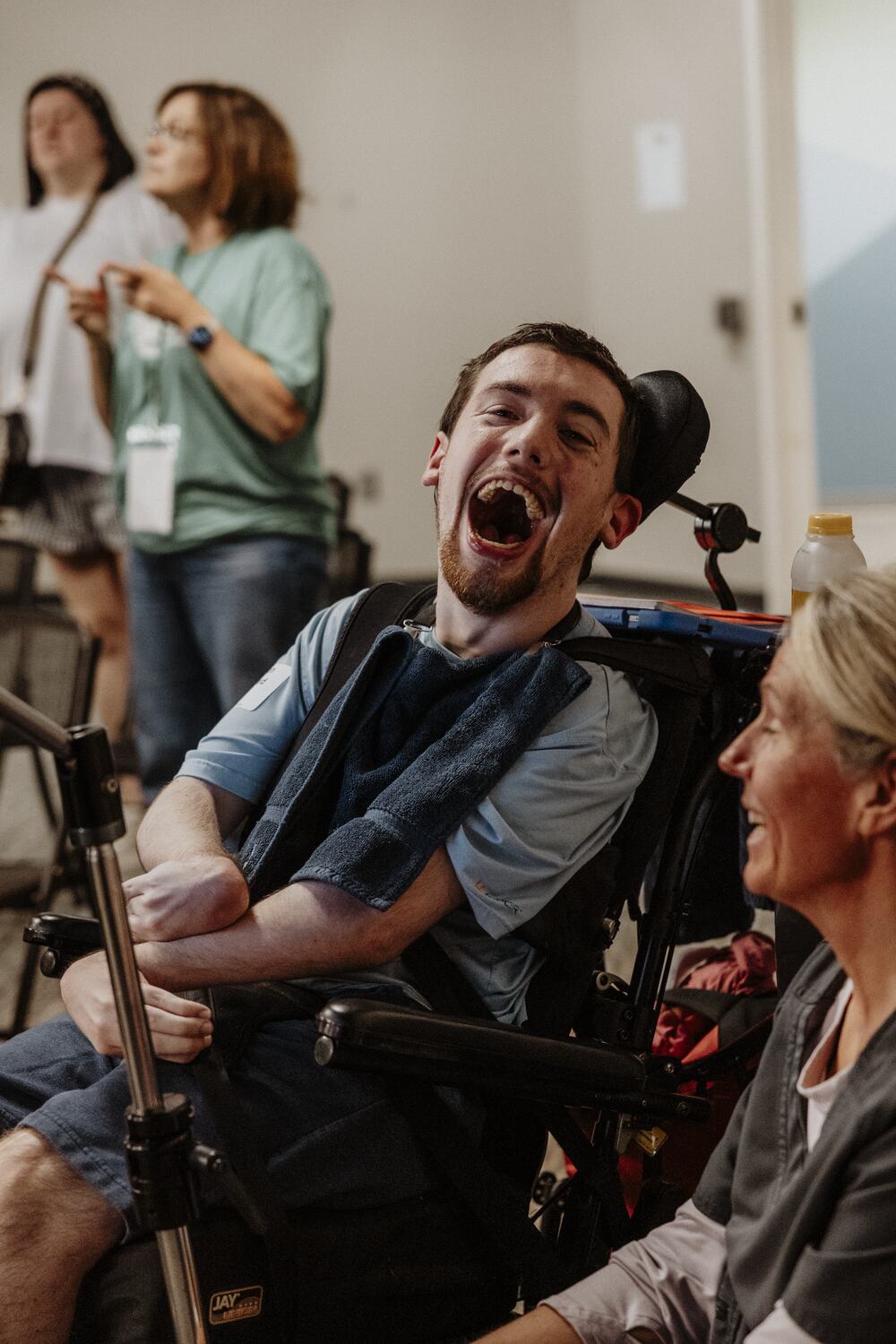 A participant laughing with a volunteer.