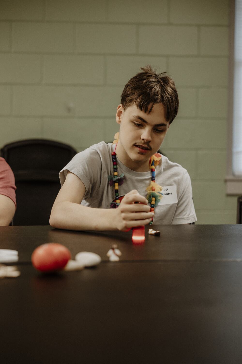 A participant at the table with a craft.