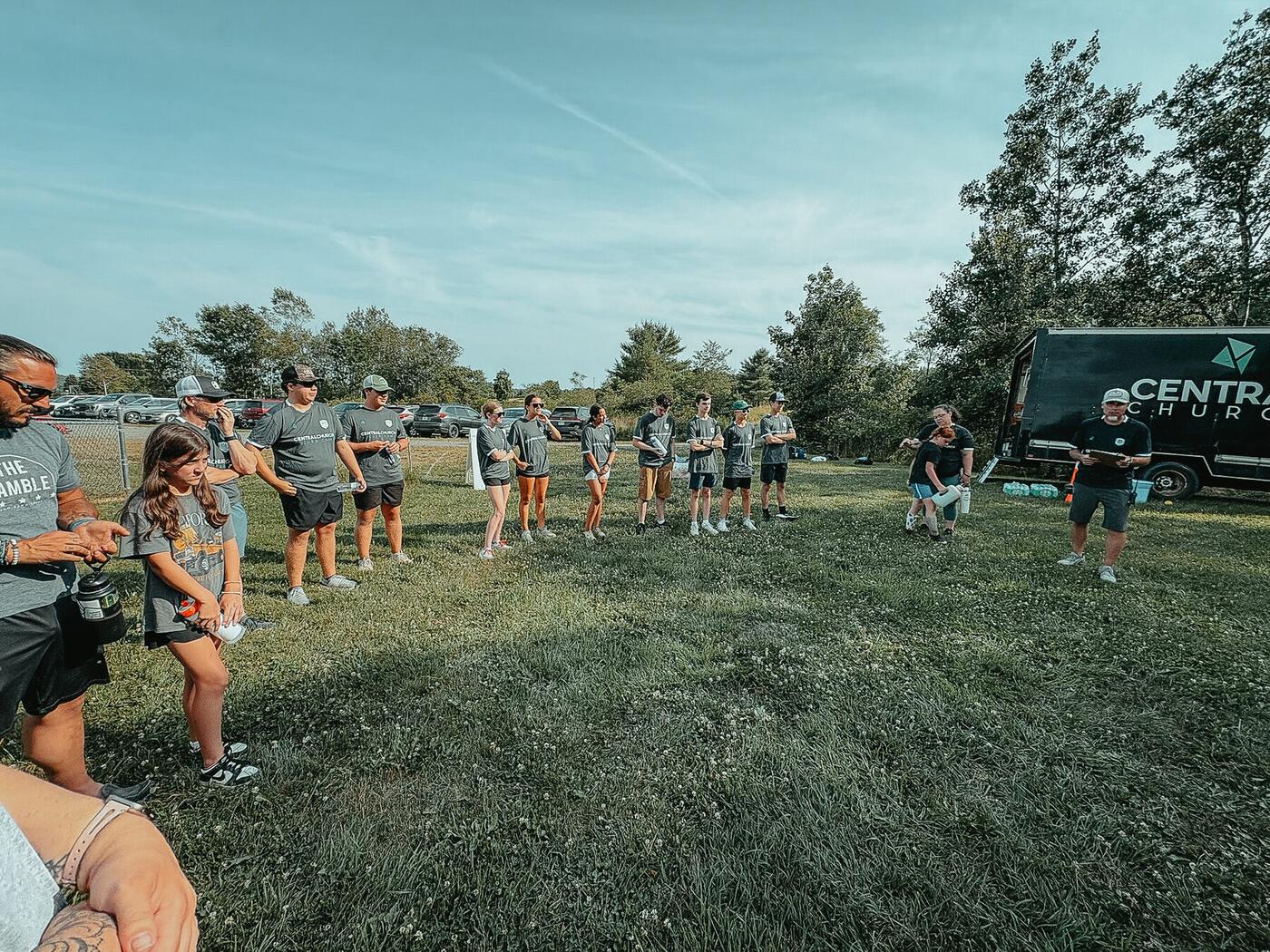 A team gathered in a circle on an open field.