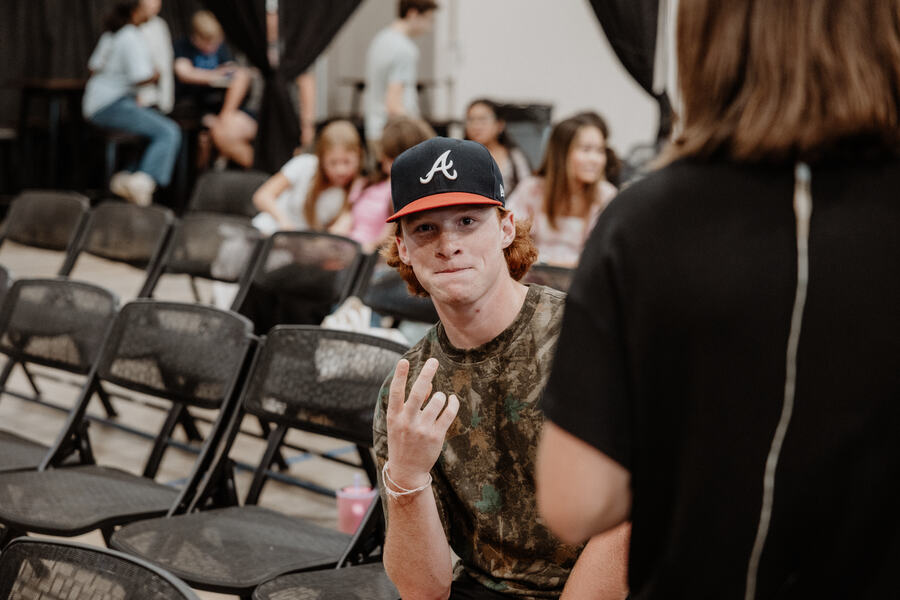 A student in the rows of chairs.