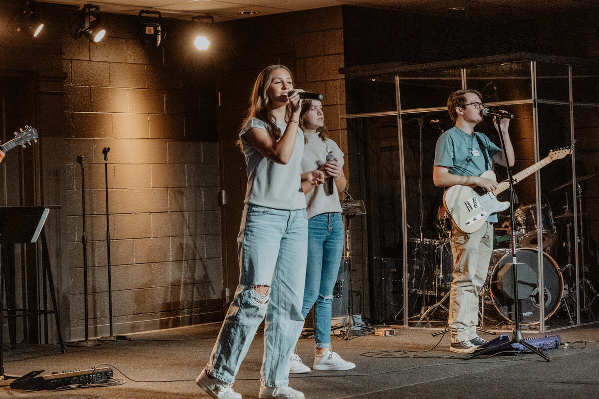 Leading a song from the stage.