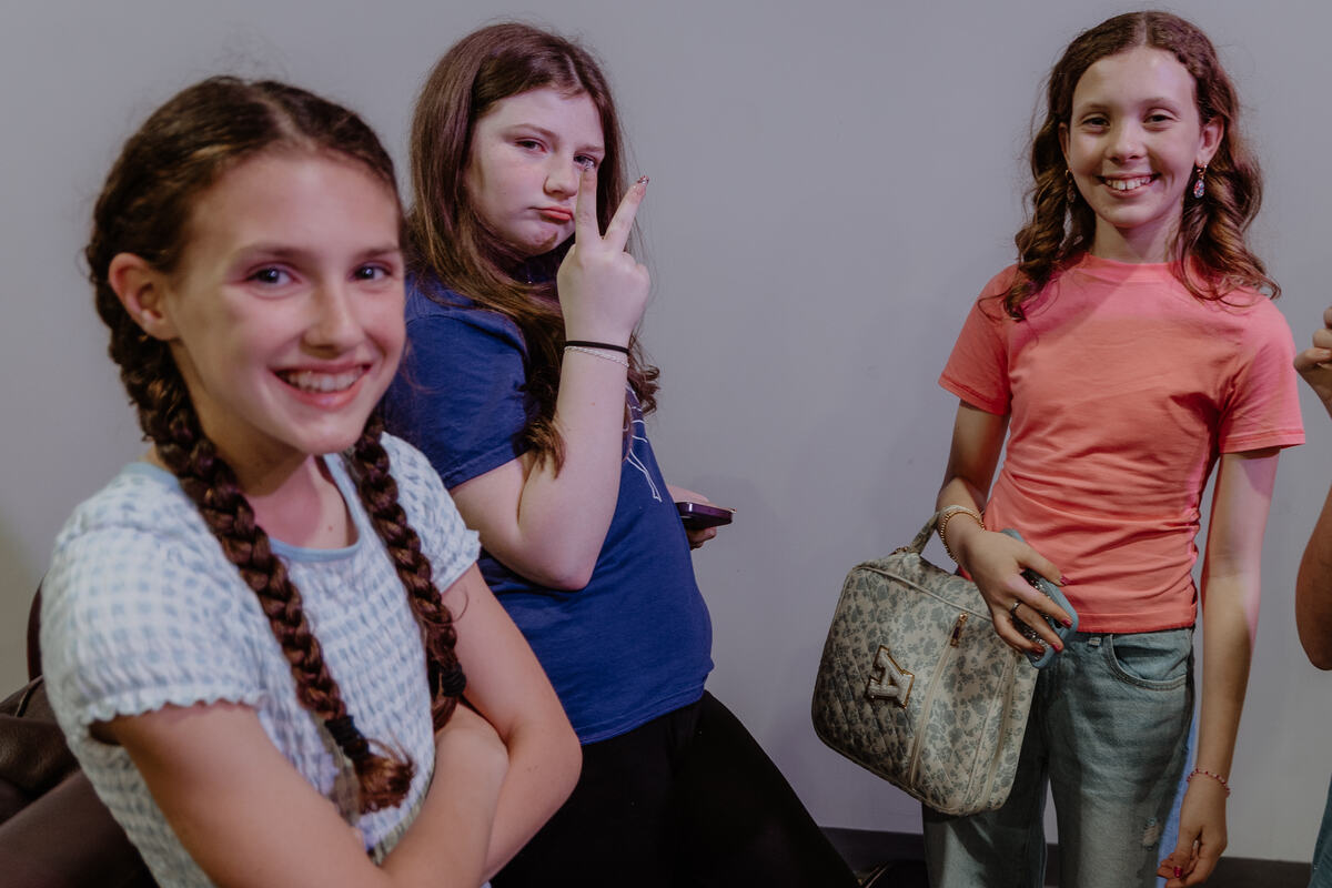 Three students together in the hallway.