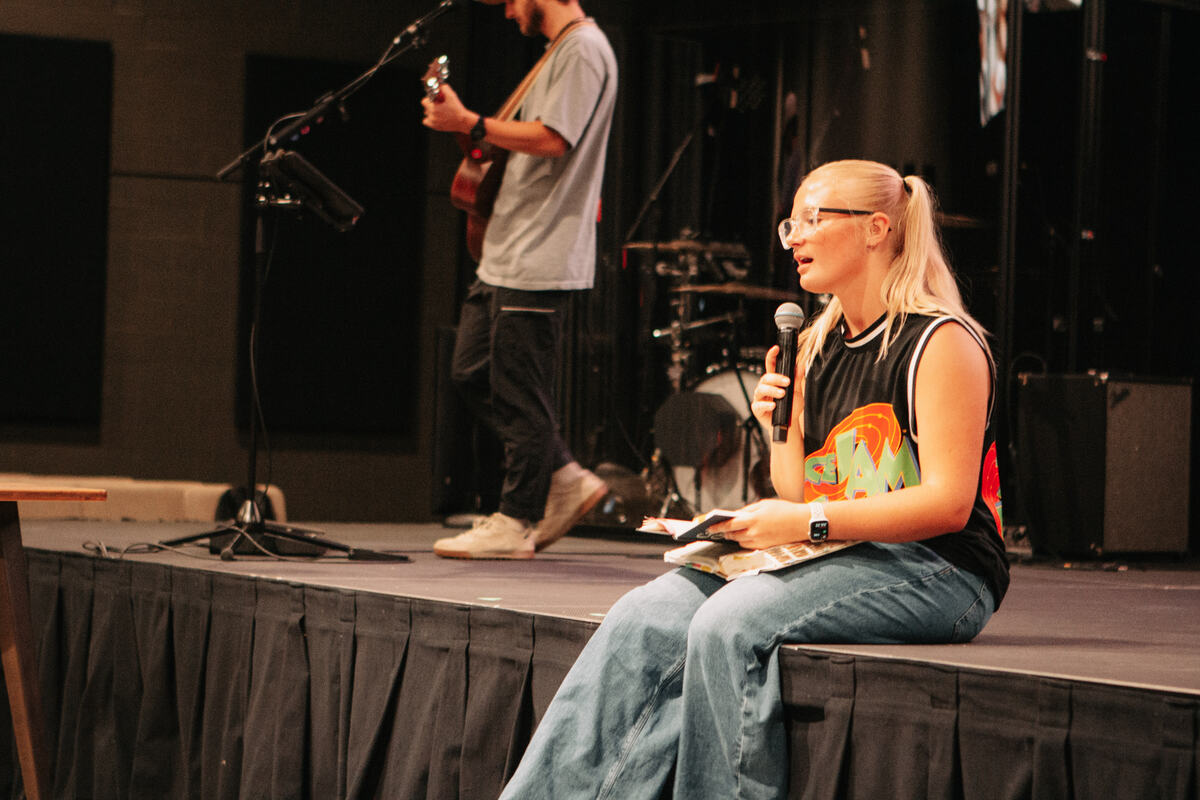 Talking with a student on stage.