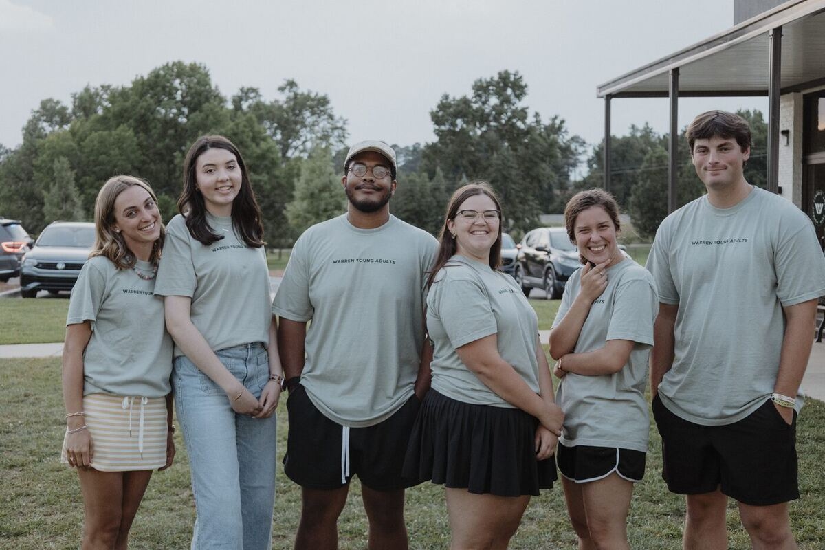 A group of young adults together outside.