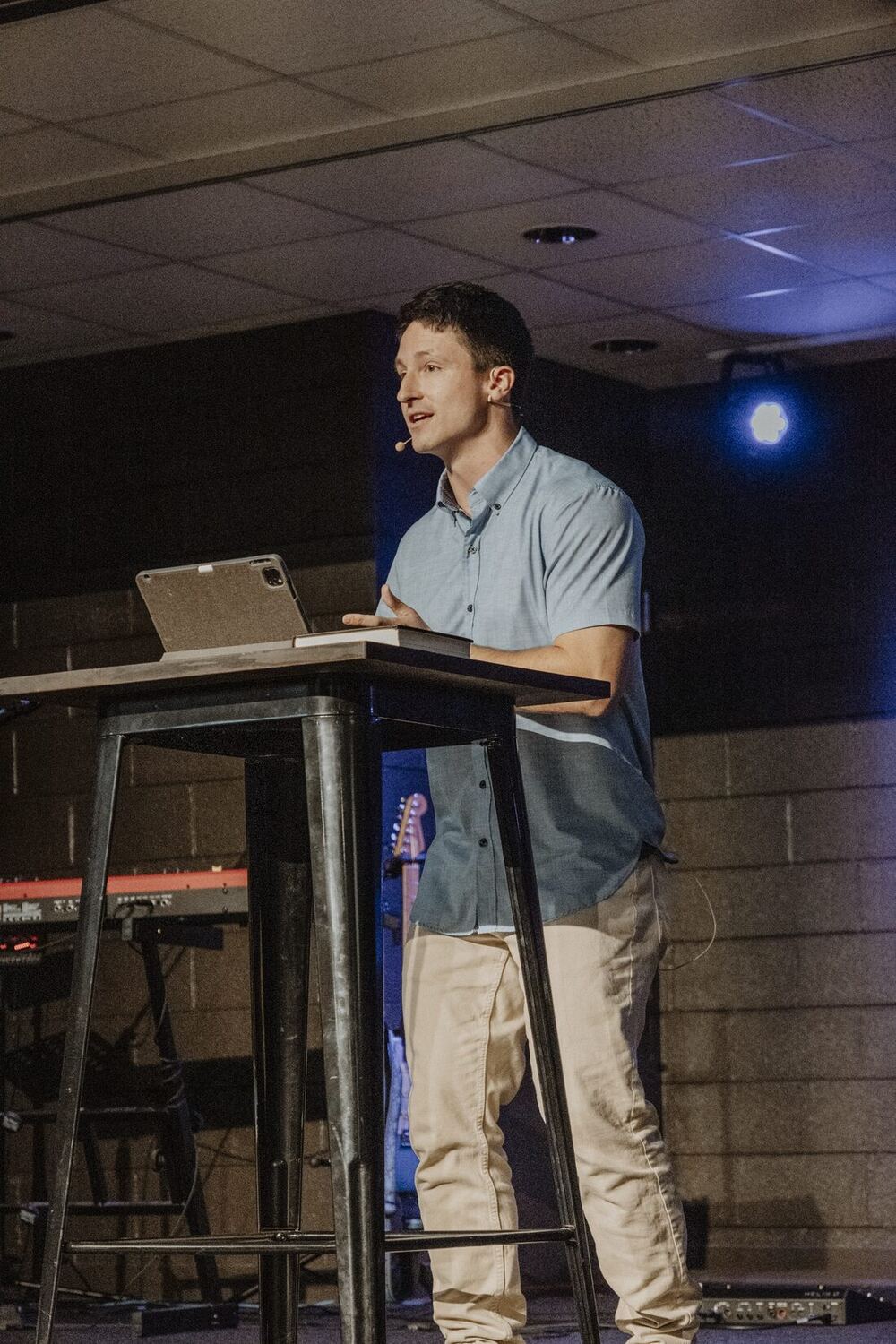 Teaching from a stand at the front of the room.